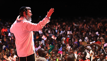 Rabbi Schneider speaking to a crowd at an international outreach